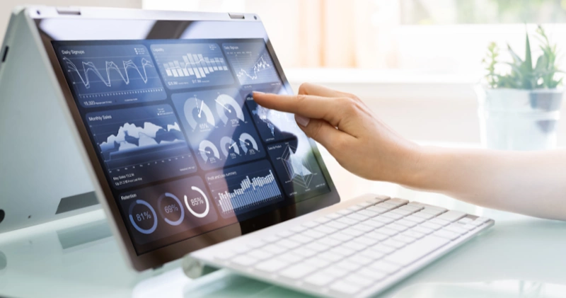 a person touching a screen on a laptop