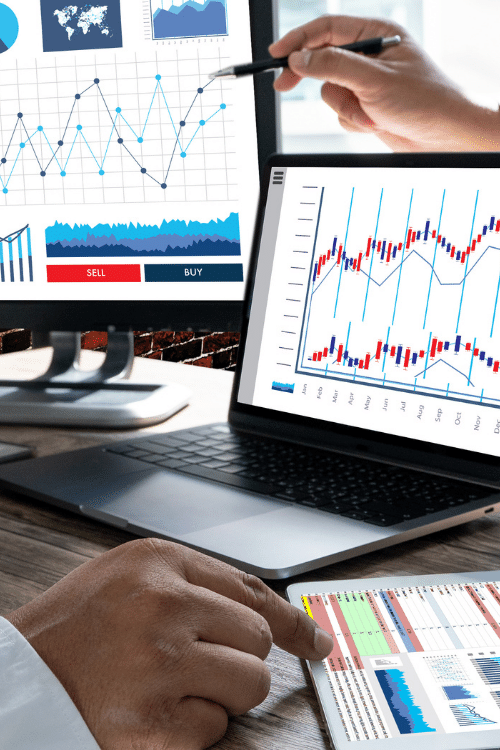 Workspace displaying financial graphs and charts as a result of utilizing full-service digital marketing services