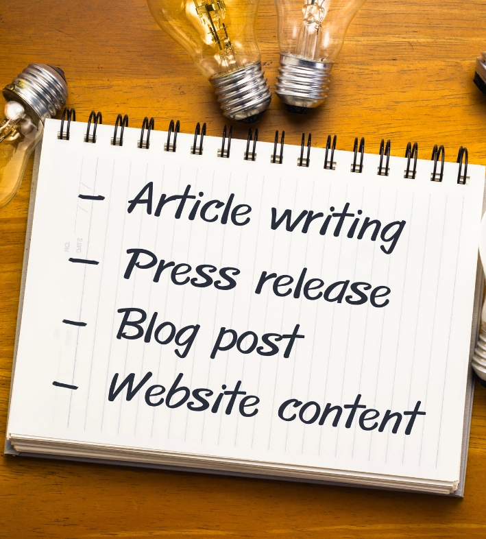 Spiral notepad listing writing services offered by a digital marketing company