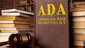 ADA Americans with Disabilities Act law book with a gavel and book stacks, illustrating the legal question: Do websites have to be ADA compliant?