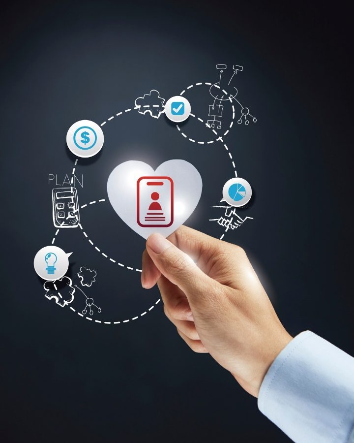 A hand holding a translucent heart with a network of symbols in the background representing SEO Services in Philippines